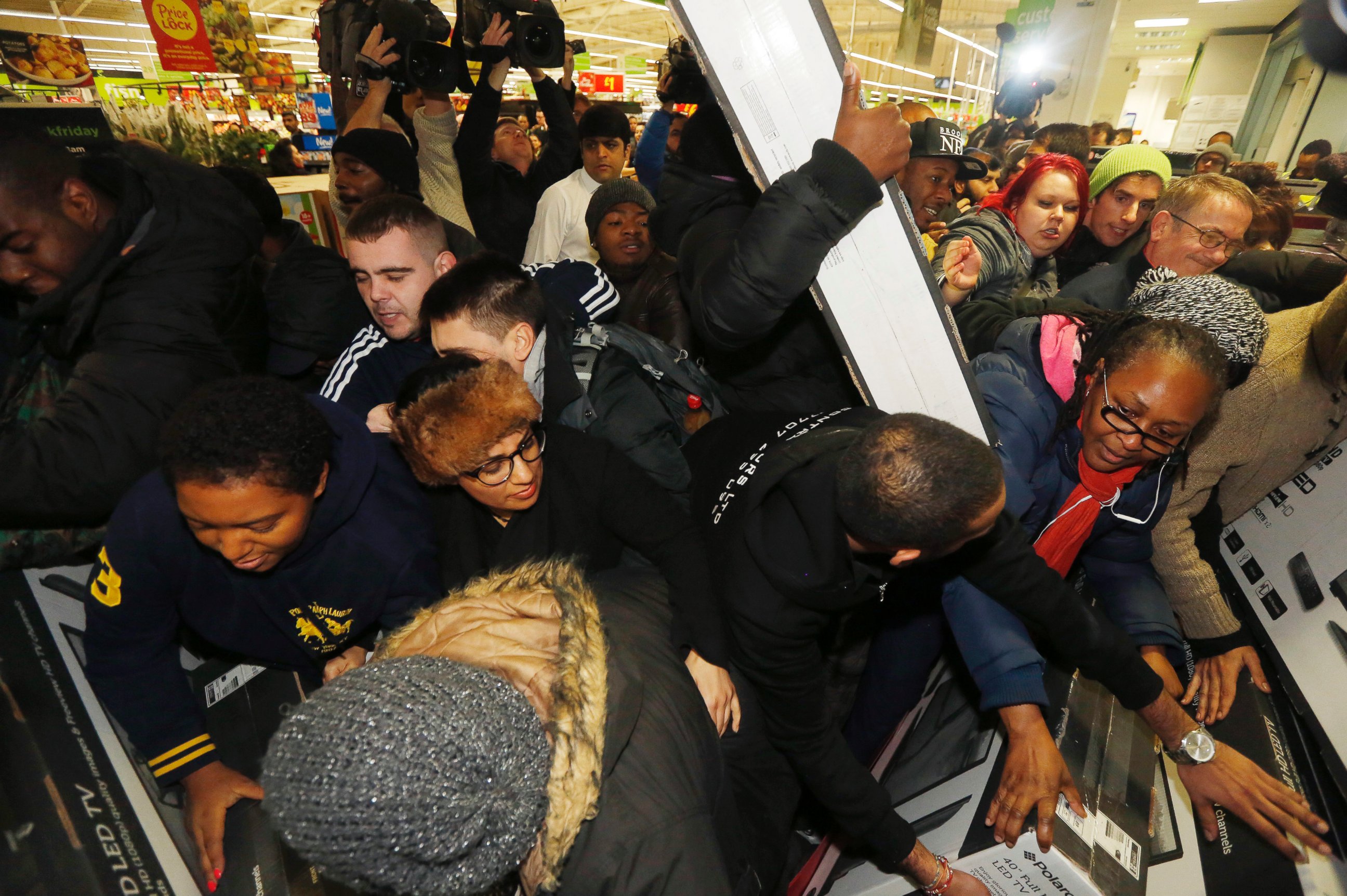 PHOTO: Shoppers compete to purchase retail items on "Black Friday" at an Asda superstore in Wembley, north London November 28, 2014.