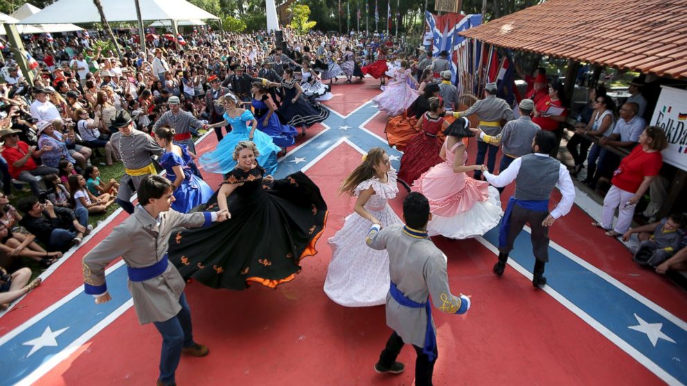 PHOTO: Descendants of American Southerners wearing Confederate-era dresses and uniforms dance during a party to celebrate the 150th anniversary of the end of the American Civil War in Santa Barbara D'Oeste, Brazil, April 26, 2015.