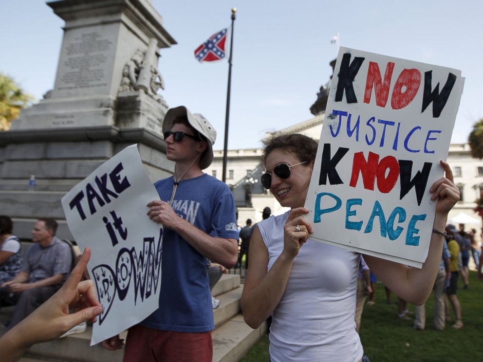 PHOTO: Micah and Nora Feinstein protest at the base of a Confederate memorial against the confederate flag in front of the South Carolina State House in Columbia, S.C., July 4, 2015.