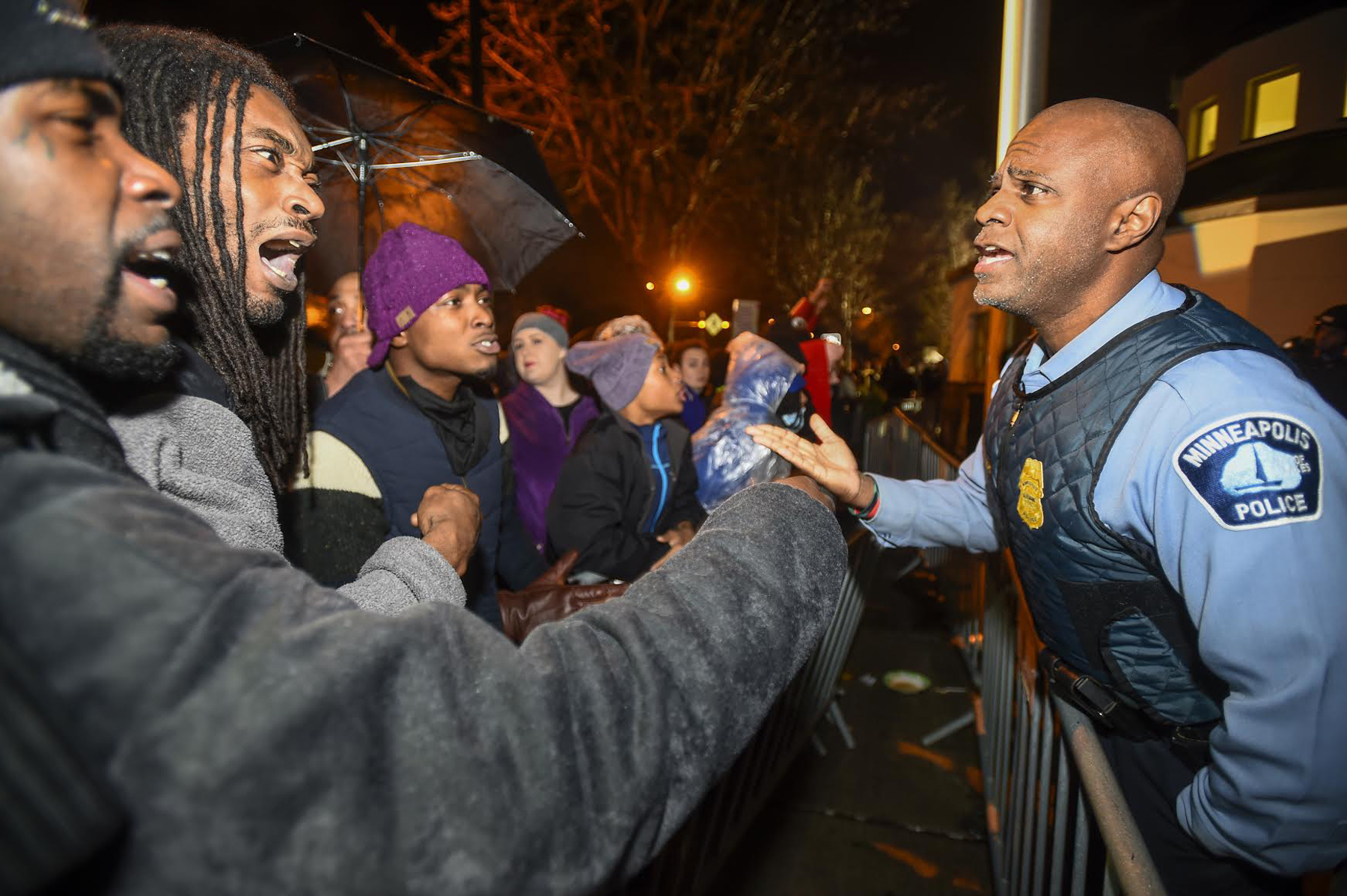 PHOTO: A police officer talks with demonstrators in front of a north Minneapolis police precinct during a protest in response of Sunday's shooting death of Jamar Clark by police officers in Minneapolis, Nov. 18, 2015.