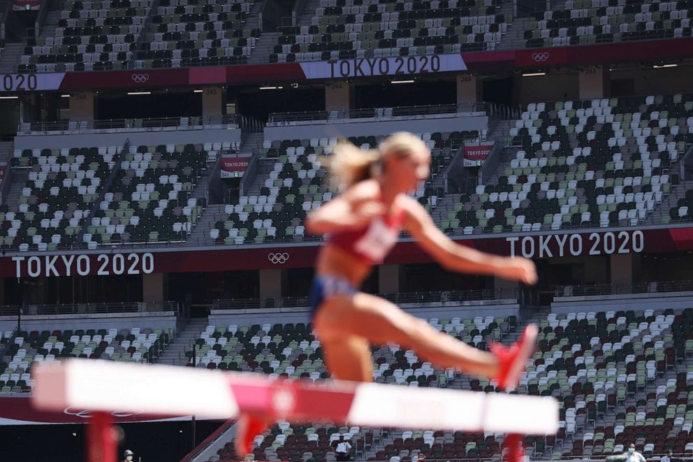 PHOTO: TOKYO, JAPAN - AUGUST 01:  Seats remain empty as Emma Coburn of Team United States competes in round one of the Women's 3000m Steeplechase heats on day nine of the Tokyo 2020 Olympic Games at Olympic Stadium on August 01, 2021 in Tokyo, Japan.