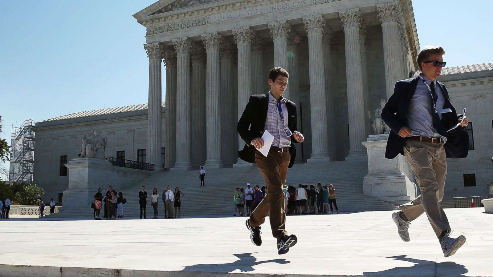 PHOTO: Two CBS interns run with a newly released Supreme Court ruling June 20, 2016 in Washington.