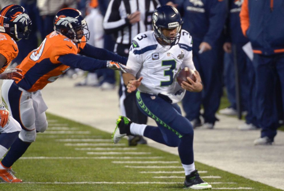 PHOTO: Russell Wilson of the Seattle Seahawks scrambles with the ball pursued by Mike Adams of the Denver Broncos during Super Bowl XLVIII on Feb. 2, 2014 at MetLife Stadium in East Rutherford, N.J.