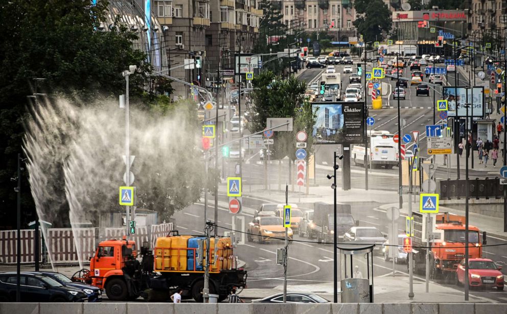 PHOTO: Municipal vehicles sprinkle water in downtown Moscow during a heat wave, July 14, 2021.