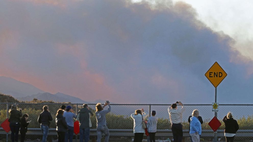 PHOTO: People gather on Poe Parkway in Stevenson Ranch to watch the fire fighting efforts on the Rye fire, Santa Clarita, Calif. Dec.5, 2017. 