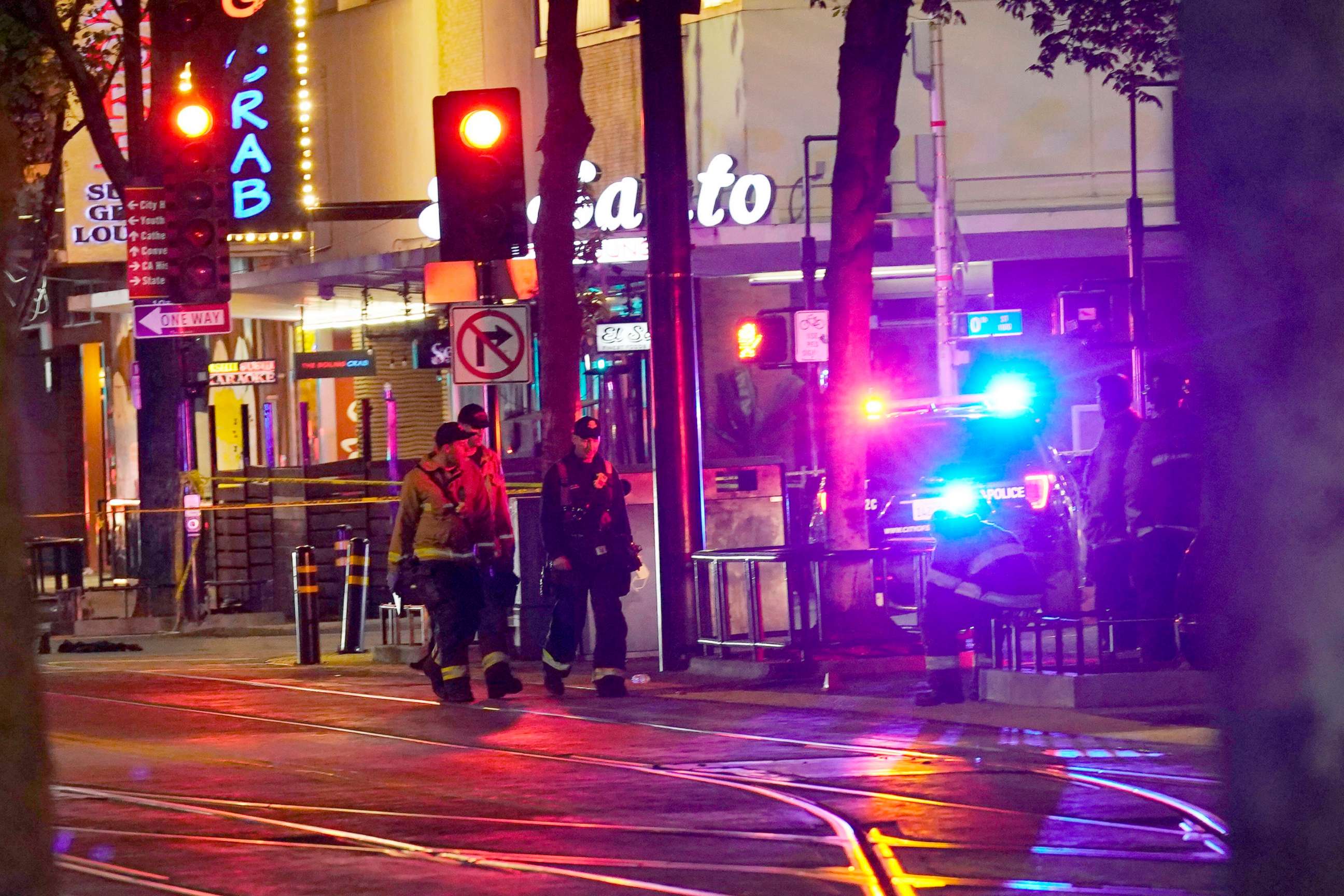 PHOTO: Emergency personnel walk near the scene of an apparent mass shooting in Sacramento, Calif., April 3, 2022.
