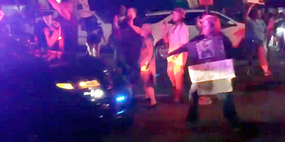 PHOTO: This photo made from video on March 31, 2018, by Guy Danilowitz shows a woman holding her arm out as a Sacramento County Sheriff's patrol vehicle approaches during a demonstration over the shooting of an unarmed black man by Sacramento police.