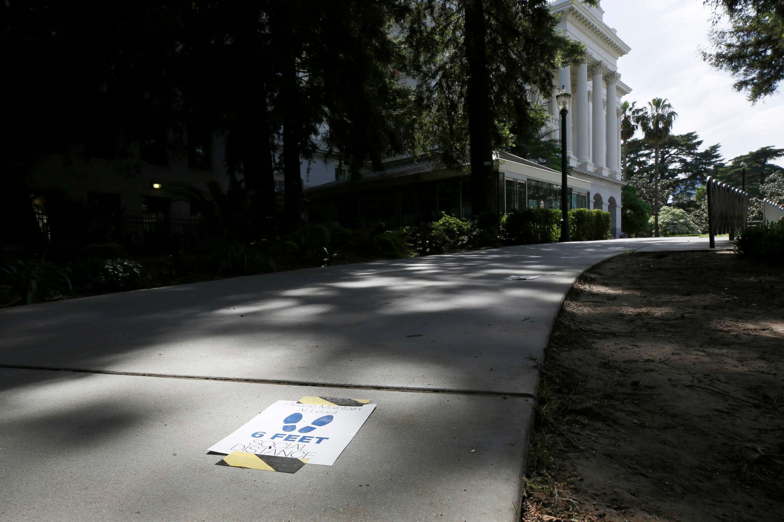 PHOTO: Signs reminding people to stay 6 feet apart are affixed to a walkway leading to the state Capitol in Sacramento, Calif., May 4, 2020, as assembly members returned to the Capitol after a nearly six-week stop due to the coronavirus pandemic.