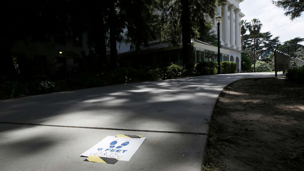 PHOTO: Signs reminding people to stay 6 feet apart are affixed to a walkway leading to the state Capitol in Sacramento, Calif., May 4, 2020, as assembly members returned to the Capitol after a nearly six-week stop due to the coronavirus pandemic.