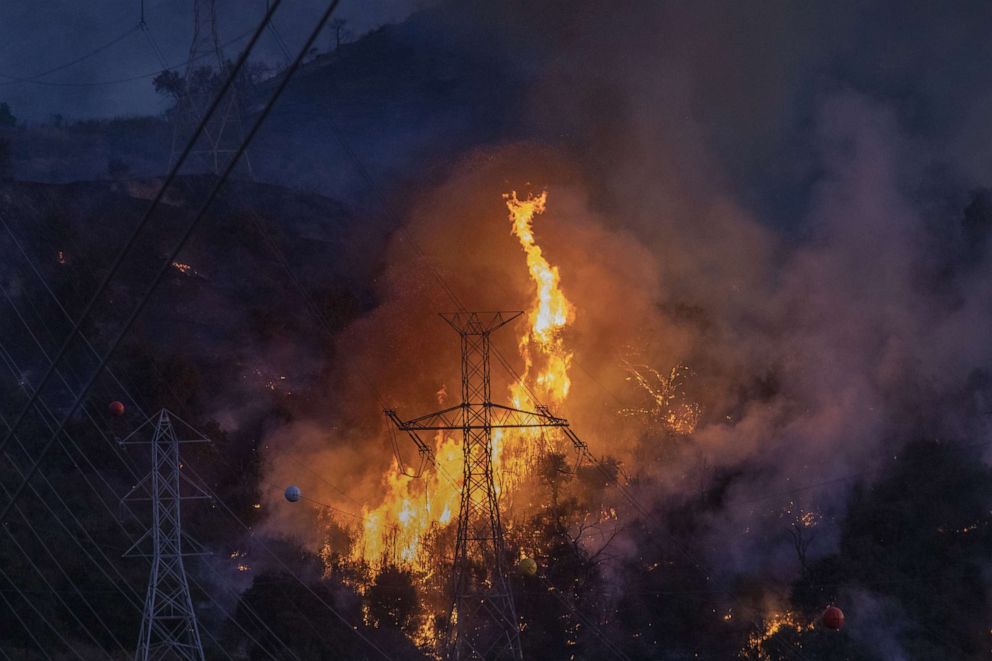 PHOTO: Flames heat up high power lines at the Saddleridge Fire on Oct. 11, 2019 near Newhall, Calif.