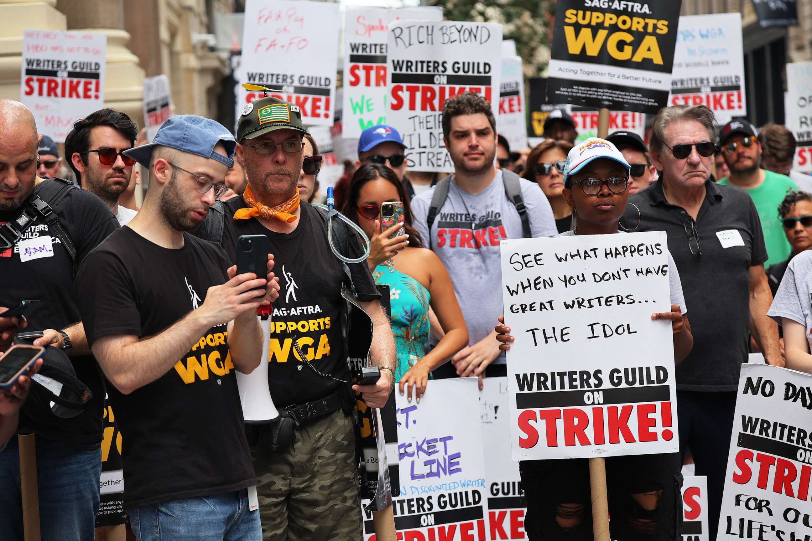 PHOTO: Members of the Writers Guild of America East are joined by SAG-AFTRA members as they picket at the Warner Bros. Discovery NYC office on July 13, 2023 in New York City.