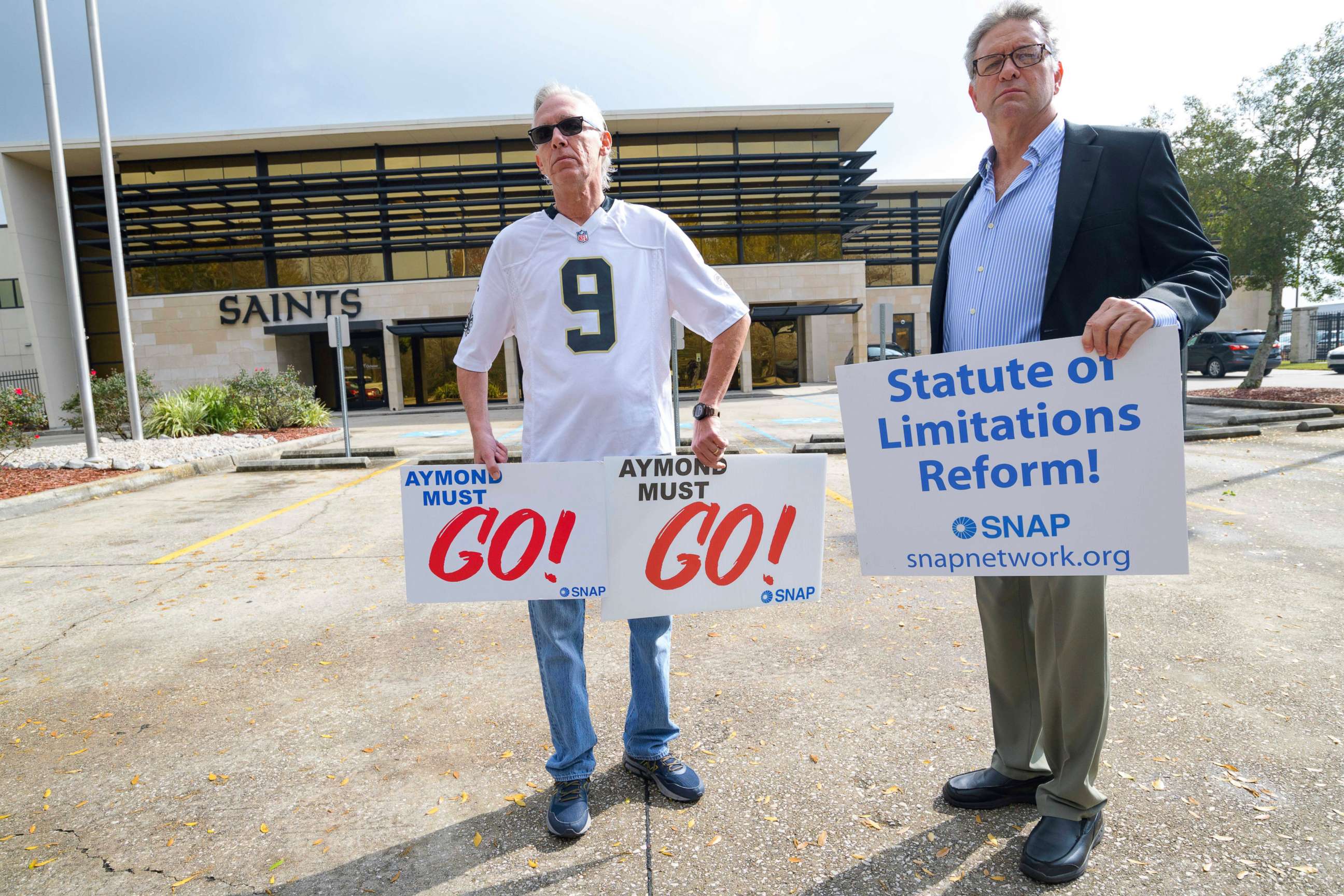 PHOTO: Richard Windmann, left, and John Gianoli, right, members of the Survivors Network of those Abused by Priests (SNAP), hold signs during a conference in front of the New Orleans Saints training facility in Metairie, La., Jan. 29, 2020.