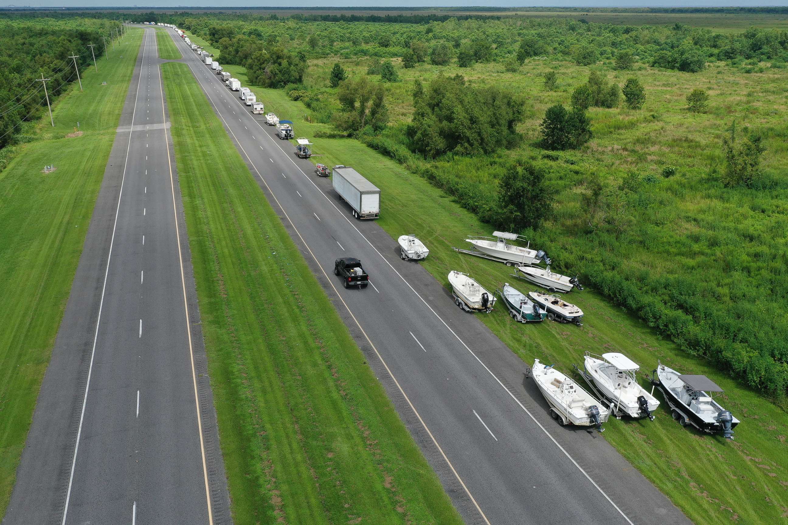 PHOTO: An aerial view from a drone shows boats and vehicles along the side of route 46 as people try to put them on higher ground before the possible arrival of Hurricane Sally on September 14, 2020 in Shell Beach, Louisiana. 