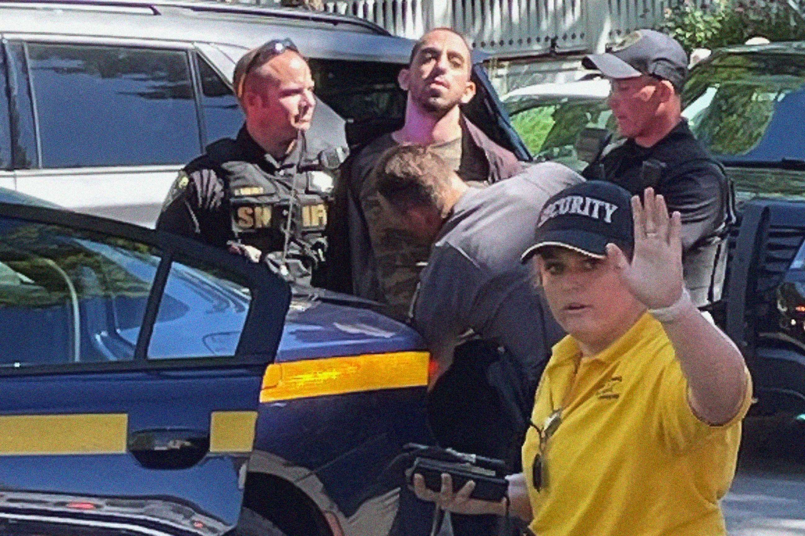 PHOTO: Law enforcement officers detain a person outside the Chautauqua Institution, in Chautauqua, N.Y., Aug. 12, 2022. Author Salman Rushdie was attacked by a man who rushed the stage, as Rushdie was about to give a lecture at the institute.