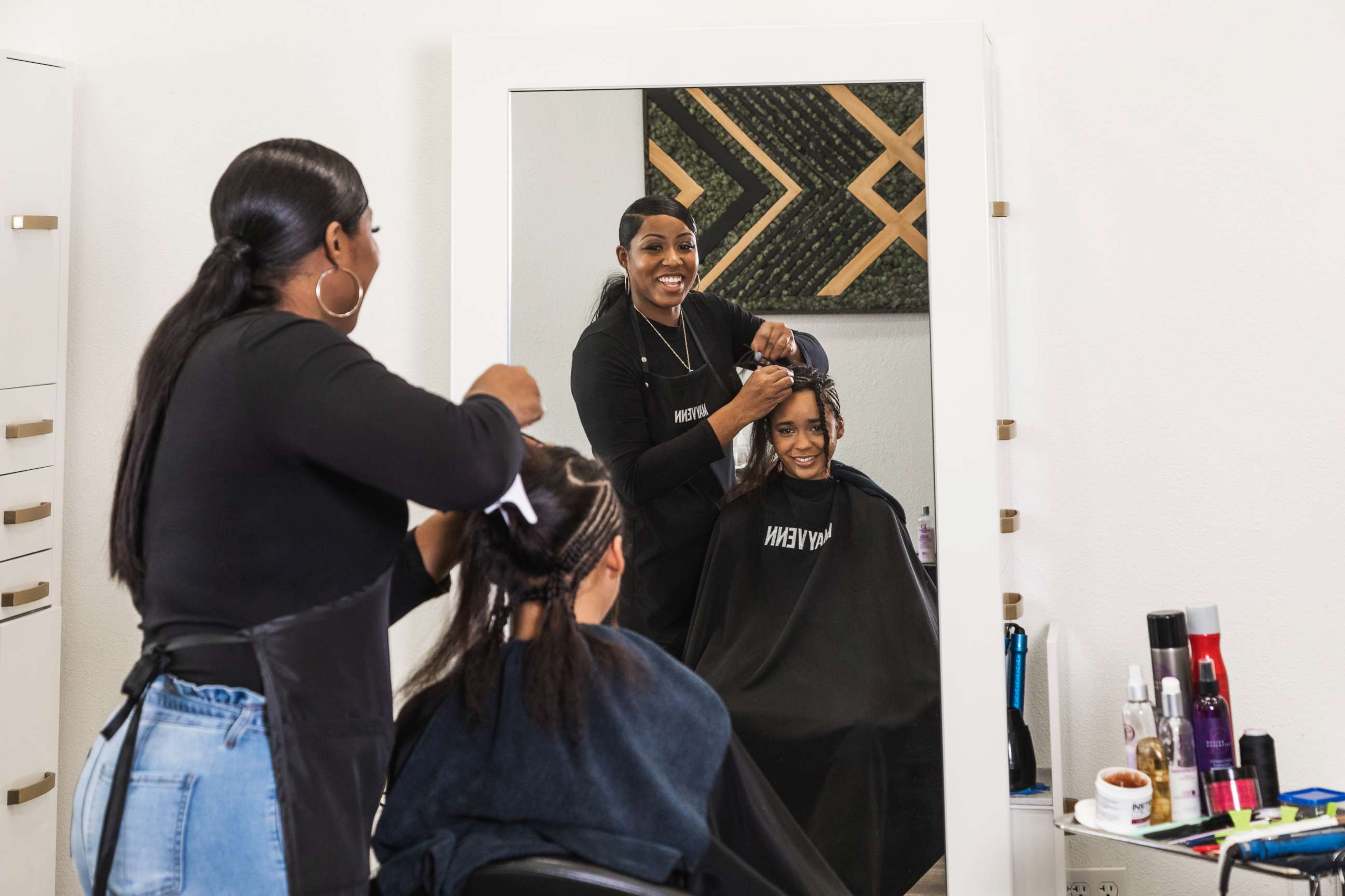 PHOTO: A young girl gets a hairstyle in a Mayvenn hair salon. 