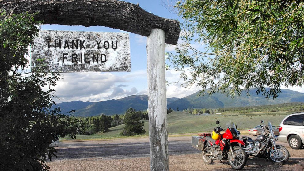 PHOTO: In this file photo taken on July 9, 2009, the Bob Marshall Wilderness cuts a jagged line across the horizon as patrons leave Trixi's Antler Saloon in Ovando, Montana.