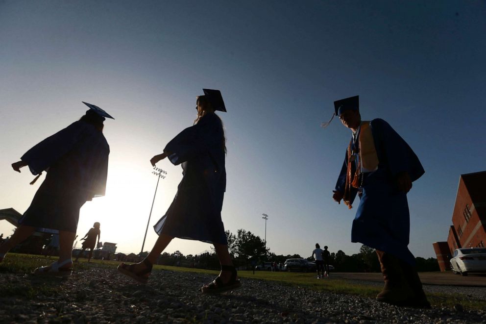 PHOTO: In this file photo taken on June 27, 2020, Saltillo High School seniors make their way to the football field as the sun begins to set for their graduation ceremony in Saltillo, Mississippi.