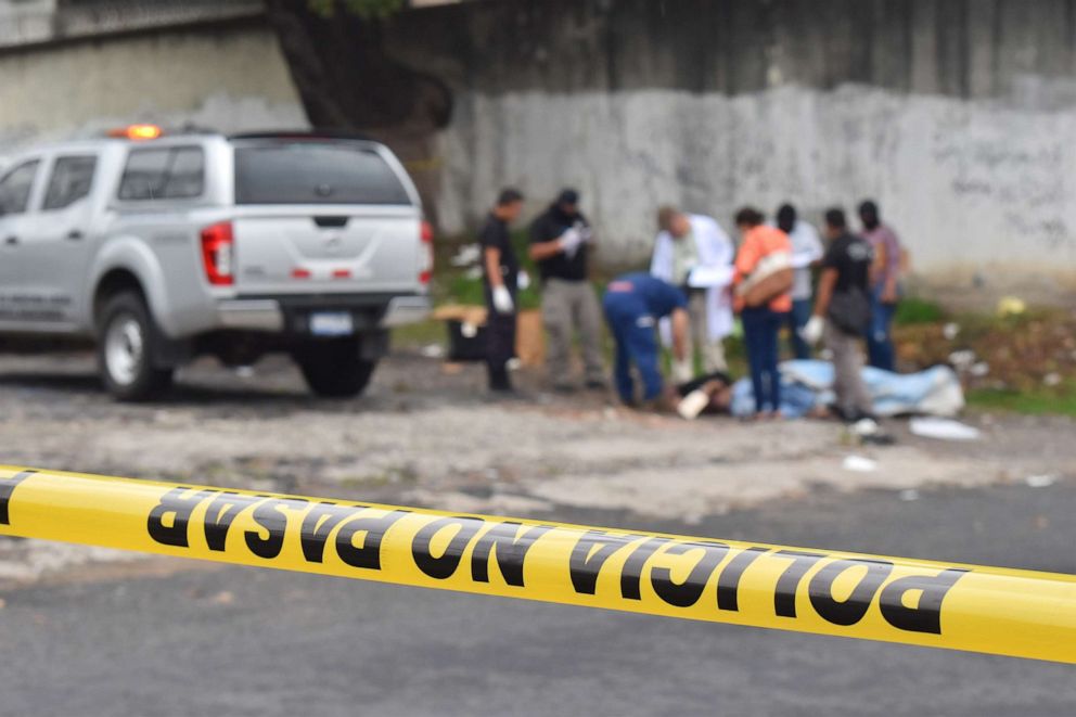 PHOTO: Salvadoran forensic police work at a crime scene, where a man was murdered, in San Salvador, May 29, 2019.