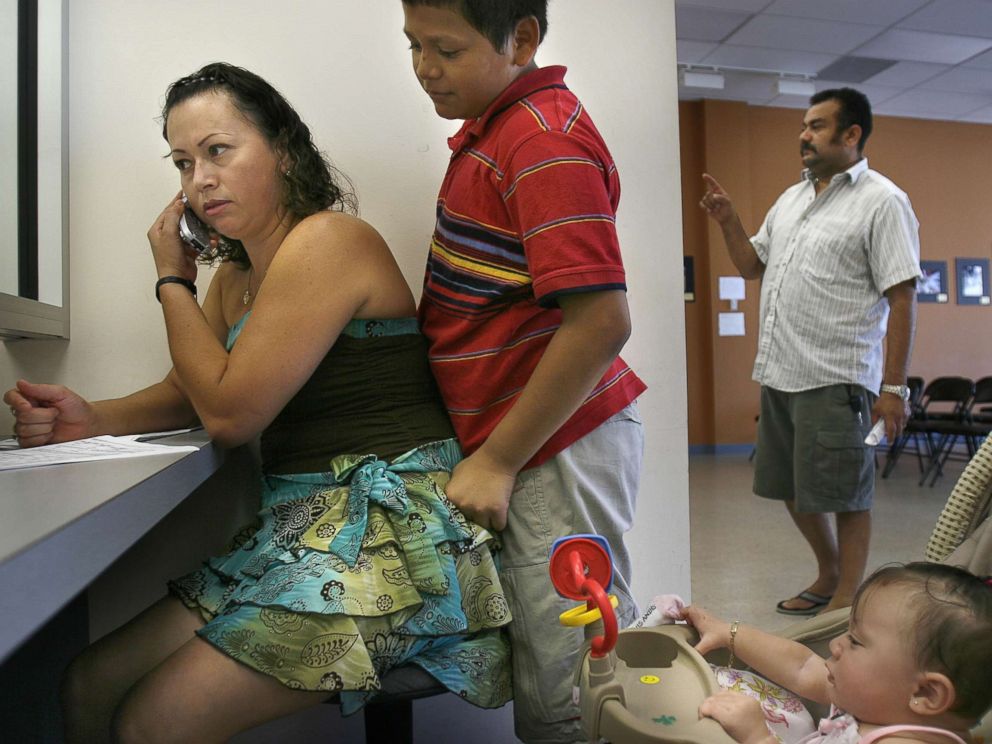 PHOTO: Selma Galindo, with her children Edgar Galindo, and daughter seven-month-old Gabriella Umanzor, apply for TPS, a permit that allows beneficiaries to work and live here legally, at the El Salvador Consulate in Woodbridge, Va., Aug. 24, 2006.