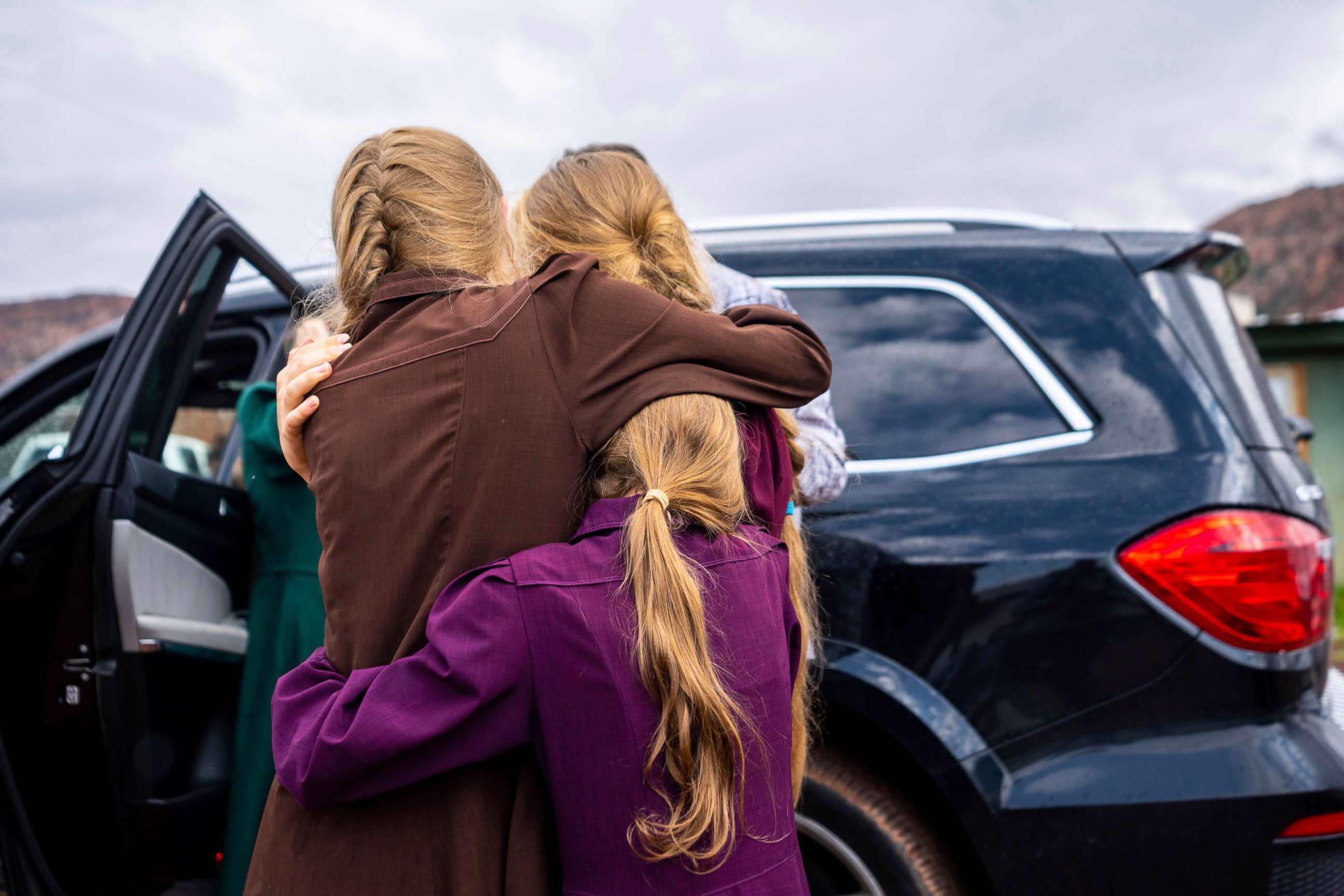 PHOTO: In this Sept. 14, 2022, file photo, three girls embrace before they are removed from the home of Samuel Bateman, following his arrest in Colorado City, Ariz.