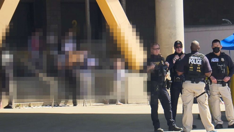 PHOTO: Police stand outside the San Diego Convention Center shelter for unaccompanied teen girls seeking asylum in the United States, March 30, 2021, in San Diego.