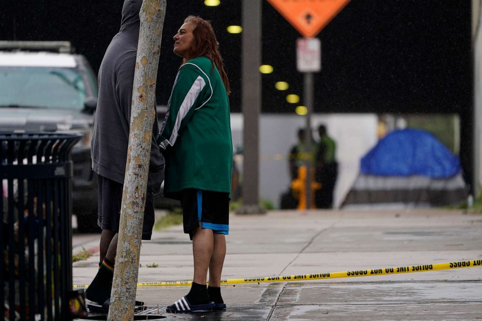 PHOTO: Lisa Brotzman, right, stands with Terry Goffigan at the scene of a deadly accident, March 15, 2021, in San Diego.