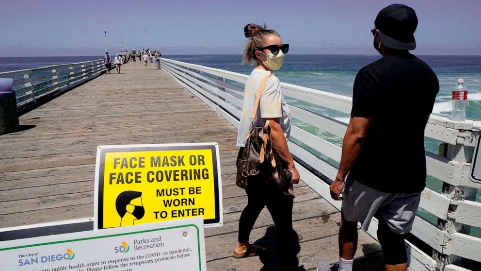 PHOTO: BBeachgoers walk out onto the Pacific Beach Pier in San Diego, Calif., on July 4, 2020, amid the coronavirus pandemic.