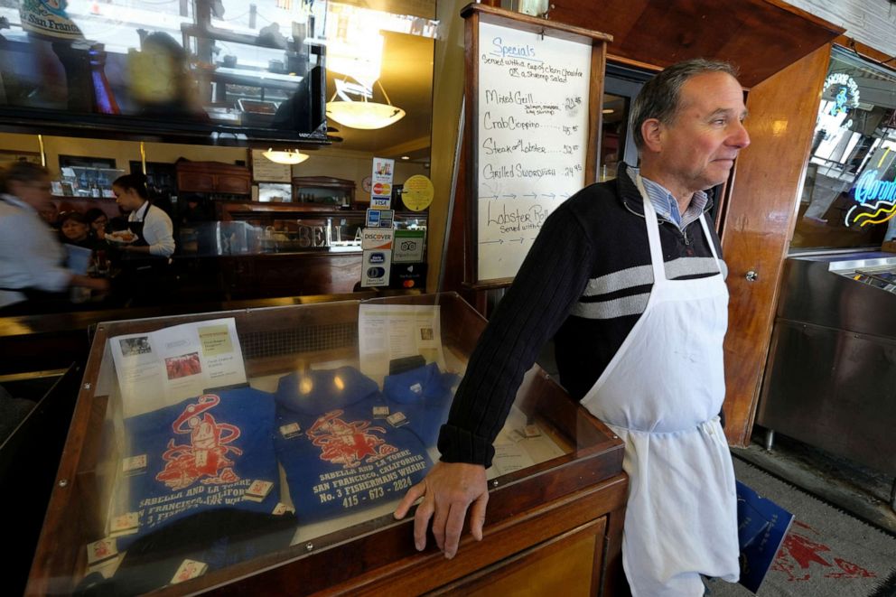 PHOTO: Tom La Torre waits to seat customers while standing outside his Sabella & LaTorre restaurant at Fisherman's Wharf, March 16, 2020, in San Francisco. 