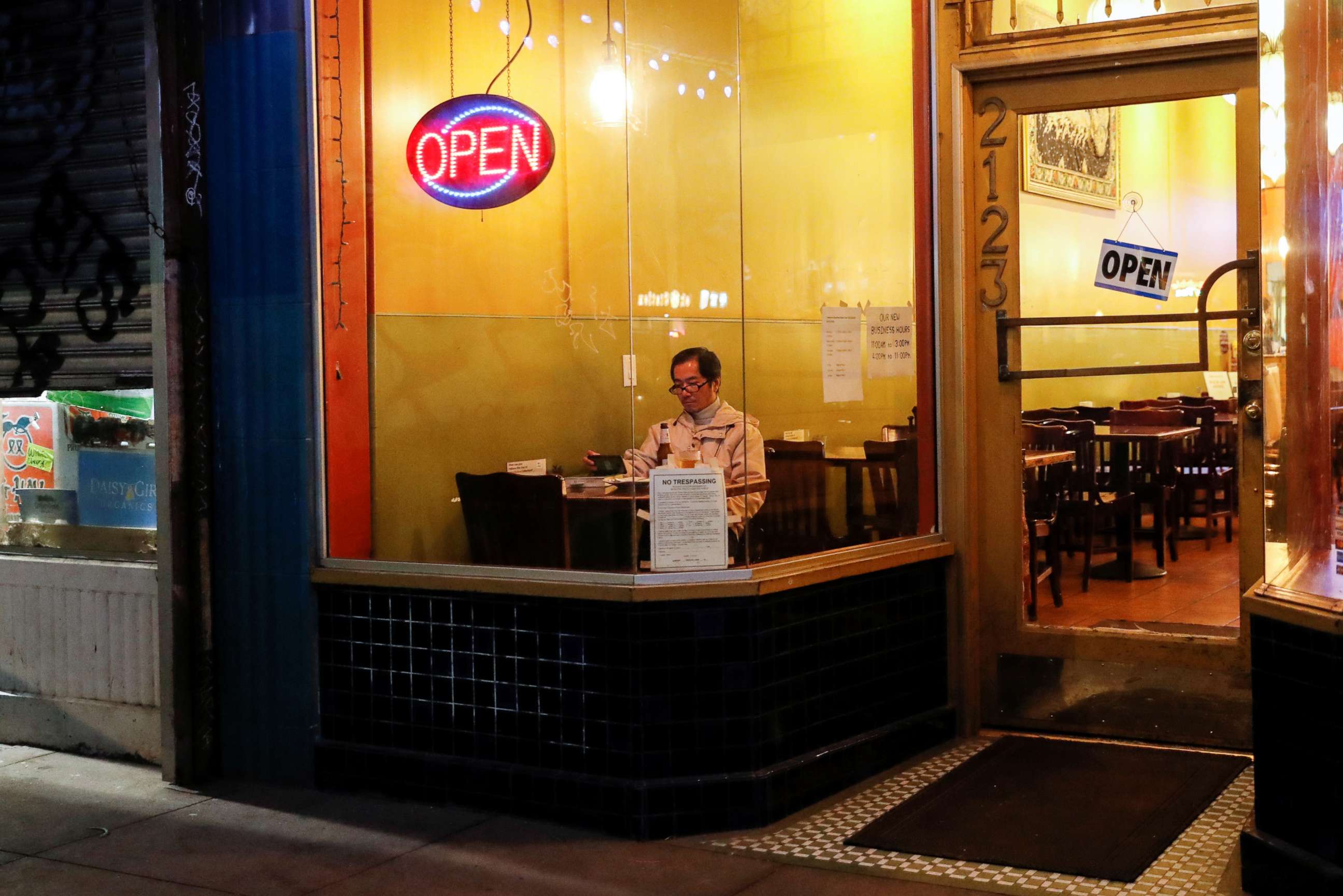 PHOTO: A man sits inside an empty restaurant on Irving Street prior to the citywide shelter in place order amid the novel coronavirus (COVID-19) outbreak, in San Francisco, March 16, 2020.