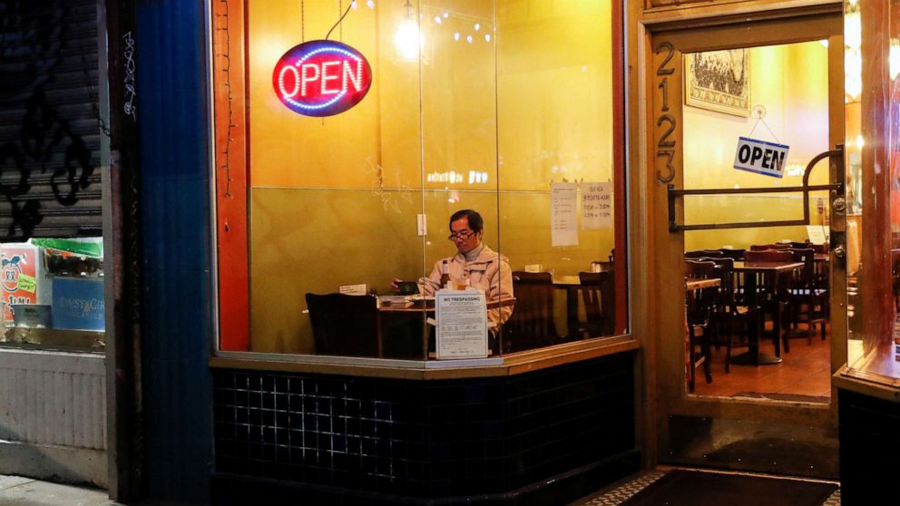 PHOTO: A man sits inside an empty restaurant on Irving Street prior to the citywide shelter in place order amid the novel coronavirus (COVID-19) outbreak, in San Francisco, March 16, 2020.