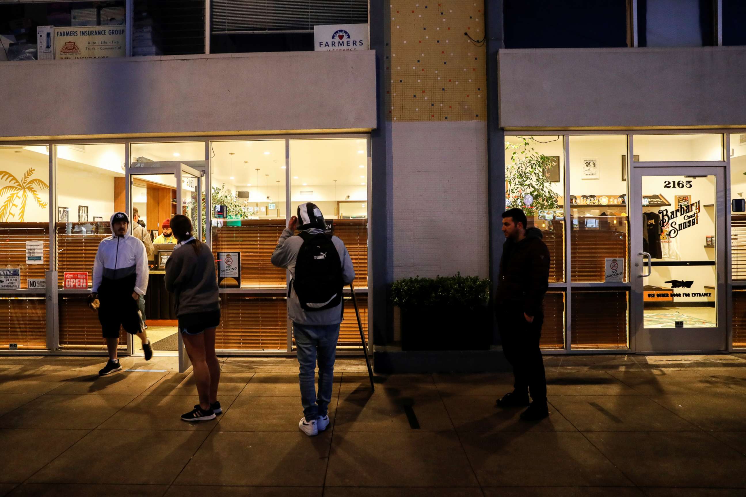 PHOTO: People stand in line outside the Barbary Coast Sunset Cannabis Dispensary prior to the citywide shelter in place order amid the novel coronavirus (COVID-19) outbreak in San Francisco, March 16, 2020.