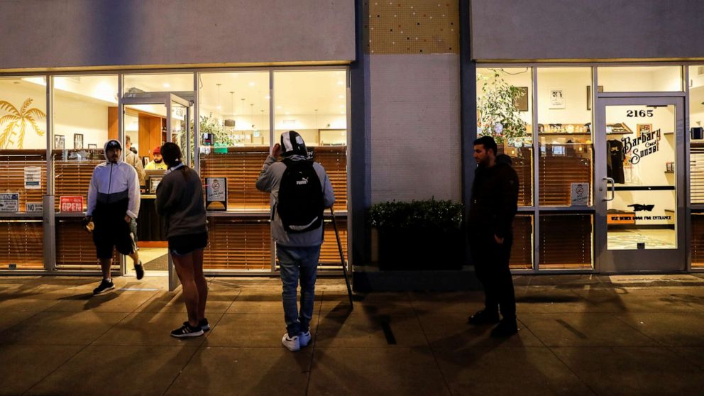 PHOTO: People stand in line outside the Barbary Coast Sunset Cannabis Dispensary prior to the citywide shelter in place order amid the novel coronavirus (COVID-19) outbreak in San Francisco, March 16, 2020.