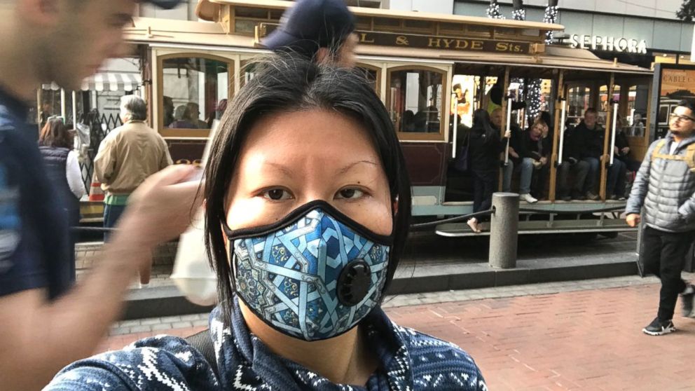 PHOTO: Jenny Shao, a graduate student in San Francisco, dons a mask Friday, Nov. 16, 2018, to protect from the city's poor air quality due to the Camp Fire. 