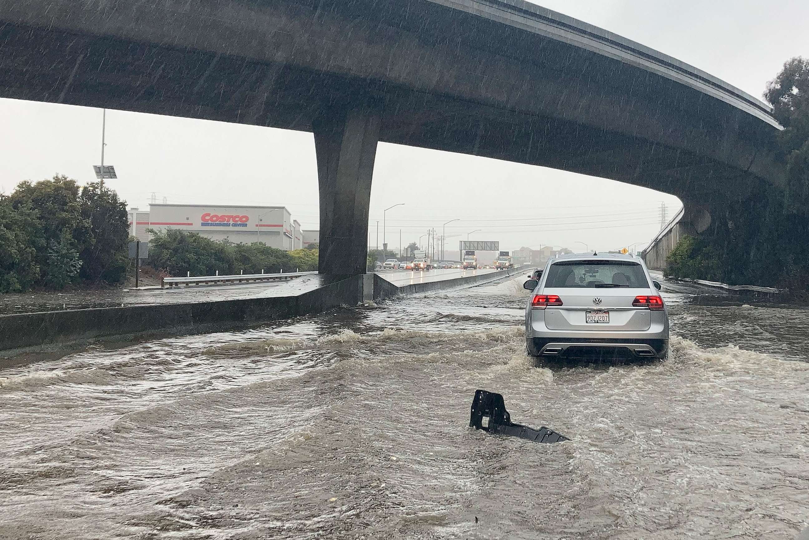 Traffic drives through flooded lanes on Highway 101 in South San Francisco, California, Dec. 31, 2022.