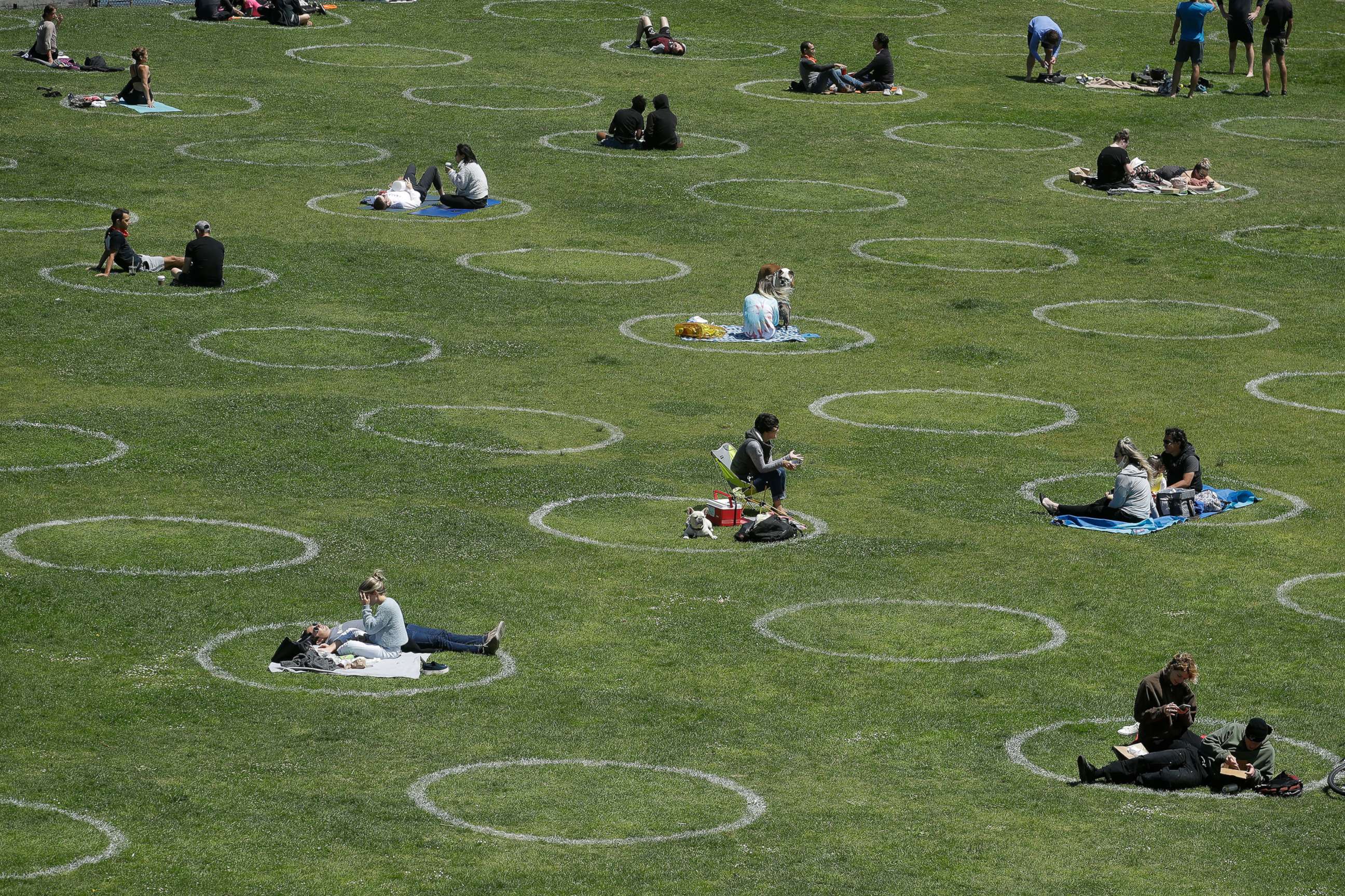 PHOTO: Visitors set up inside circles designed to help prevent the spread of the coronavirus by encouraging social distancing, at Dolores Park in San Francisco, Calif., June 28, 2020.