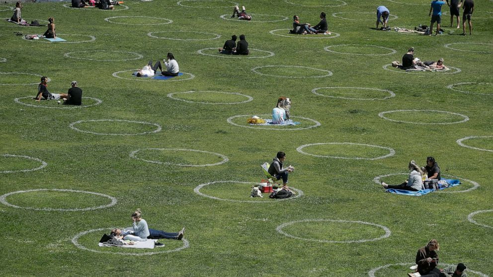 PHOTO: Visitors set up inside circles designed to help prevent the spread of the coronavirus by encouraging social distancing, at Dolores Park in San Francisco, Calif., June 28, 2020.