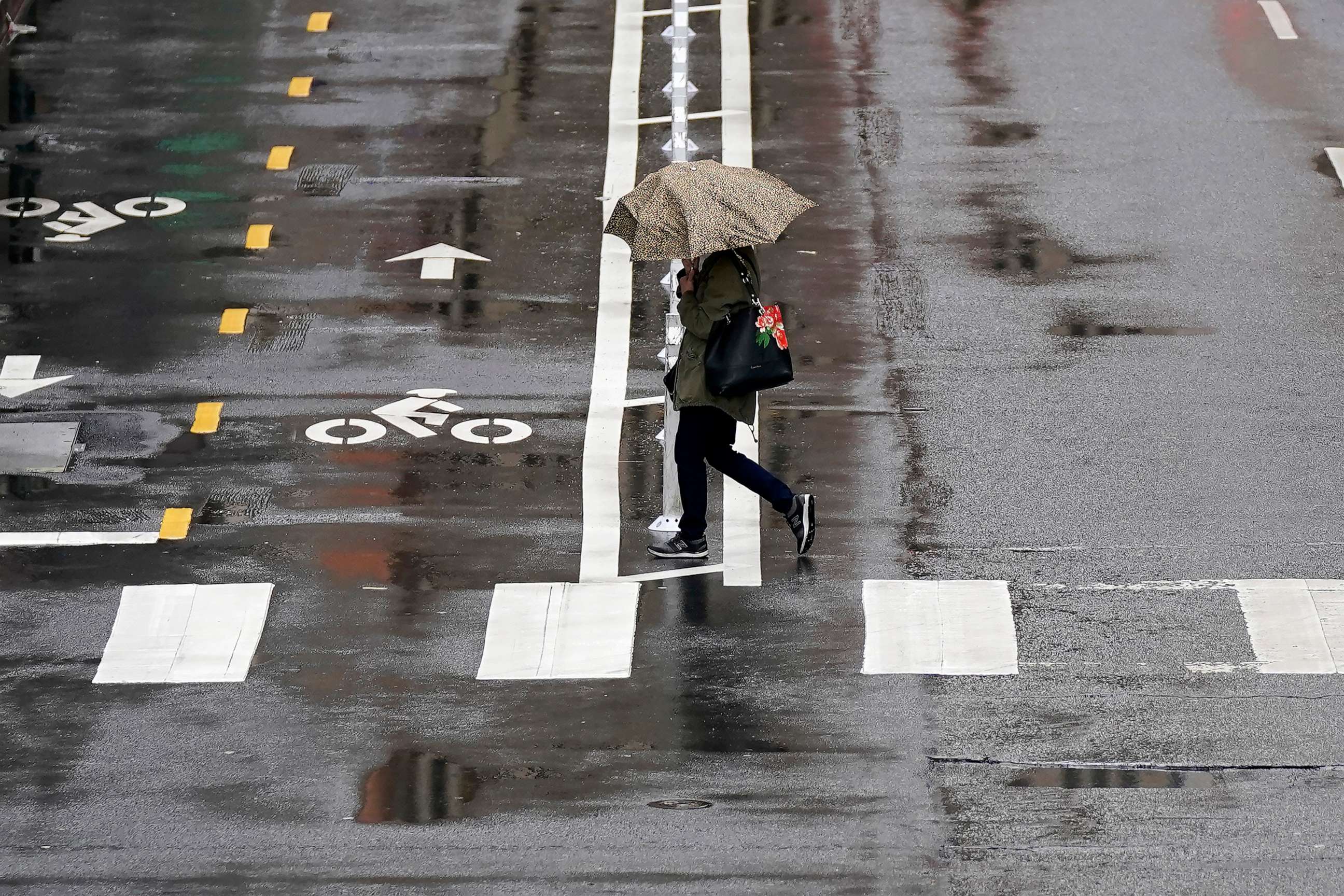 PHOTO: A pedestrian carries an umbrella while walking in San Francisco, on March 14, 2023.