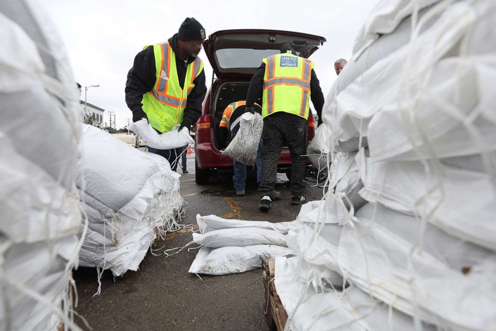 PHOTO: San Francisco Department of Public Works workers load sandbags into a car on Jan. 3, 2023, in San Francisco.