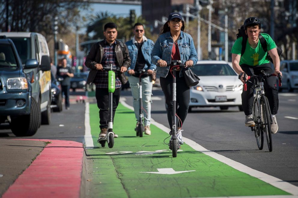 PHOTO: People ride electric scooters on the Embarcadero in San Francisco, April 13, 2018. 