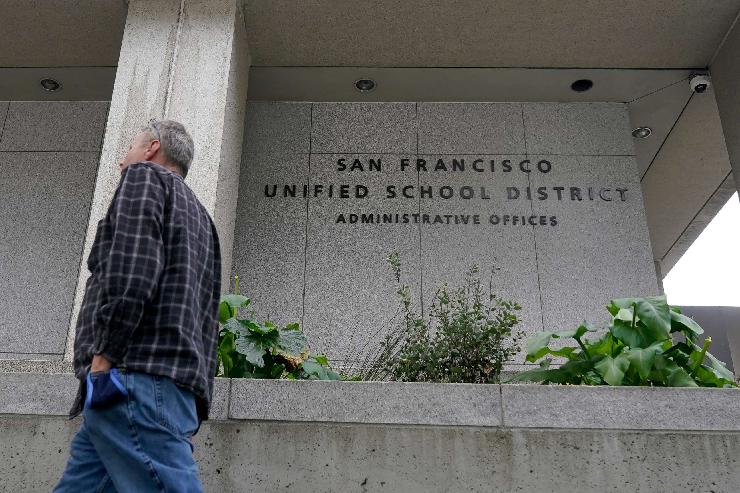 PHOTO: A pedestrian walks past a San Francisco Unified School District office building in San Francisco, California, on Feb. 3, 2022.