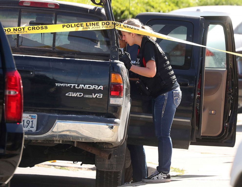 PHOTO: A forensic analyst with the San Jose Police Department searches a truck near scene where five people were killed Monday, June 24, 2019, in San Jose, Calif.