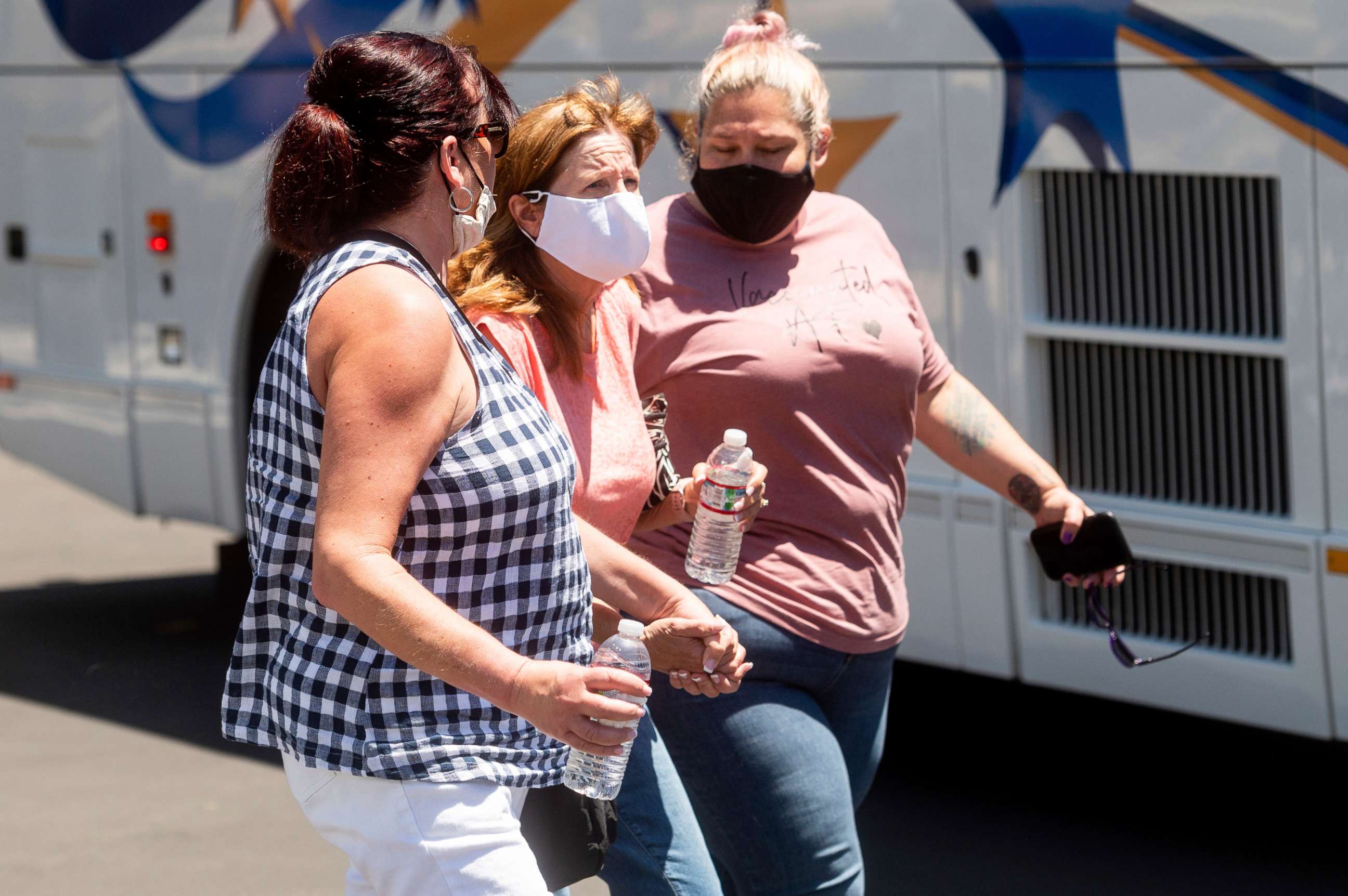 PHOTO: Women leave a gathering area for Santa Clara Valley Transportation Authority workers and family members following a shooting at one of the agency's rail yards on Wednesday, May 26, 2021, in San Jose, Calif.