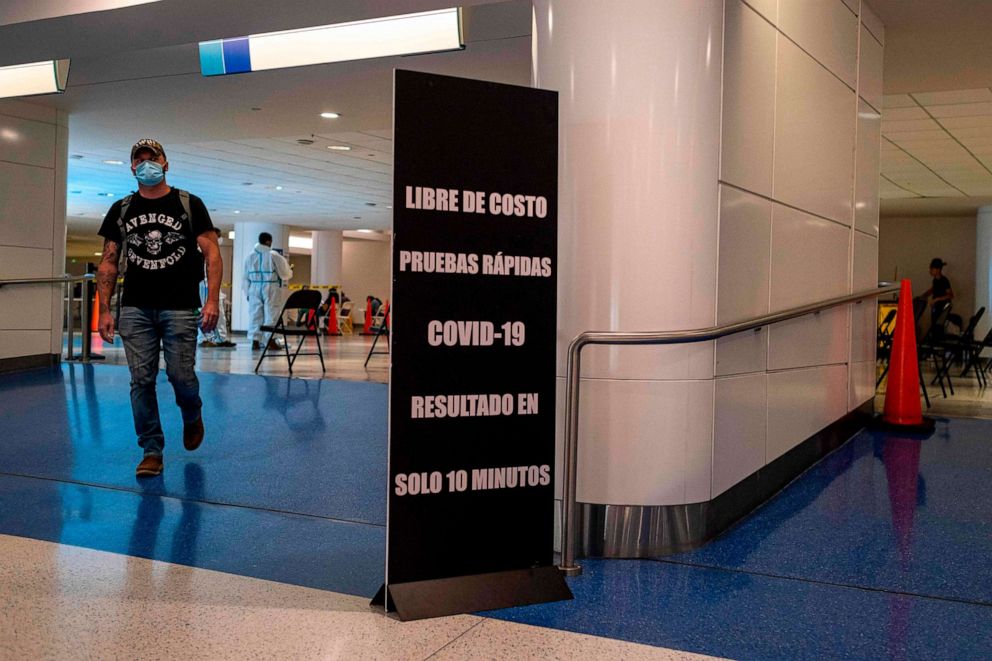 PHOTO: A passenger exits the voluntary free COVID-19 rapid test area provided to passengers arriving at the Luis Munoz Marin Airport in San Juan, Puerto Rico, on June 30, 2020.