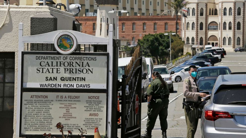 PHOTO: A correctional officer checks a car entering the main gate of San Quentin State Prison, July 9, 2020, in San Quentin, Calif.