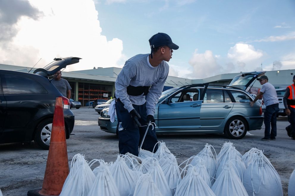 PHOTO: Miami Beach public works department workers fill sandbags and help load them into residents' cars in Miami Beach, Florida, August 31, 2019 in preparation for hurricane Dorian.