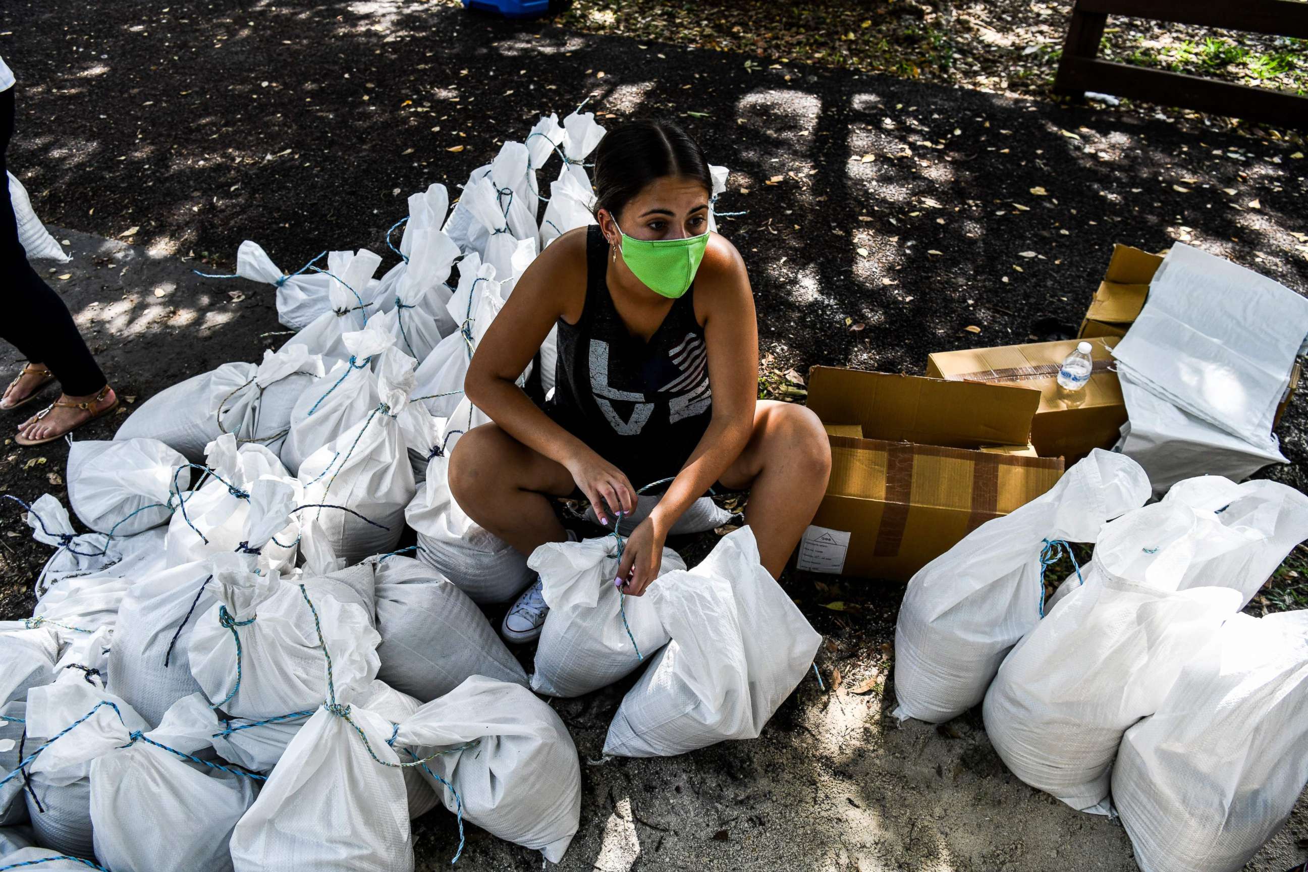 PHOTO: A woman prepares sand bags for distribution to the residents of Palmetto Bay near Miami, on July 31, 2020, as Floridians prepare for Hurricane Isaias.