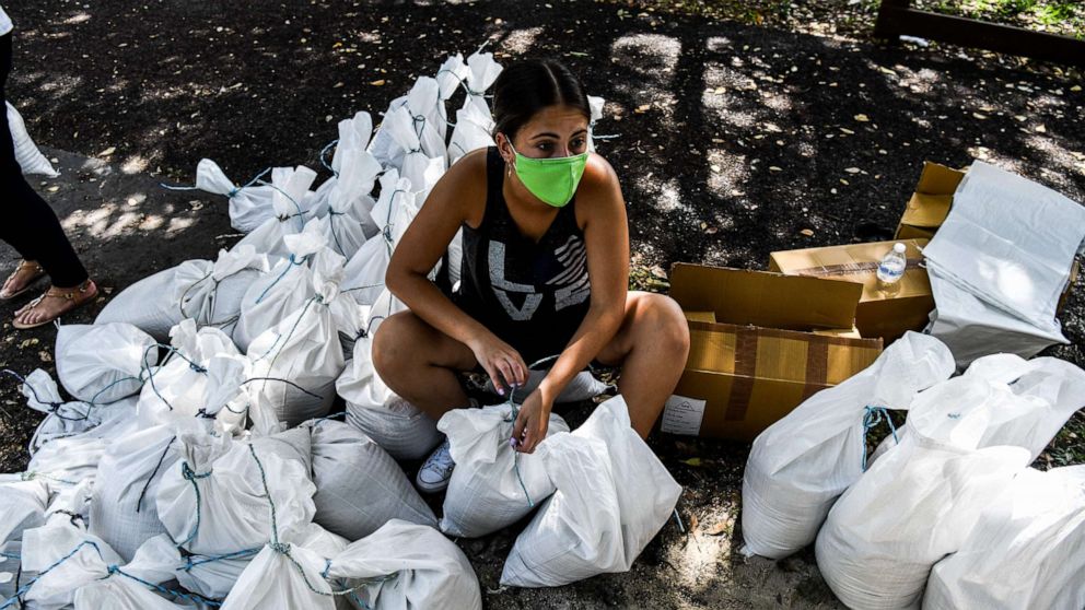 PHOTO: A woman prepares sand bags for distribution to the residents of Palmetto Bay near Miami, on July 31, 2020, as Floridians prepare for Hurricane Isaias.