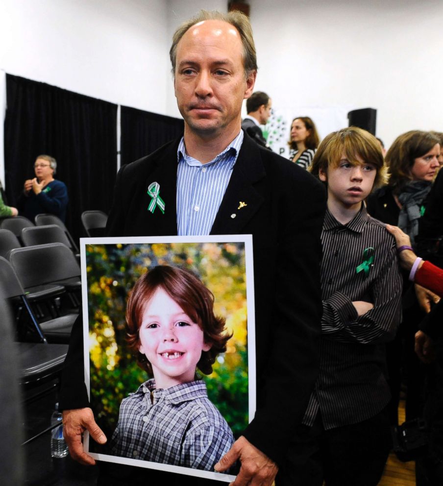 PHOTO: John Barden, father of Sandy Hook Elementary School shooting victim Daniel Barden holds a photograph of his son as he leaves a news conference in Newtown, Conn., Jan. 14, 2013. 