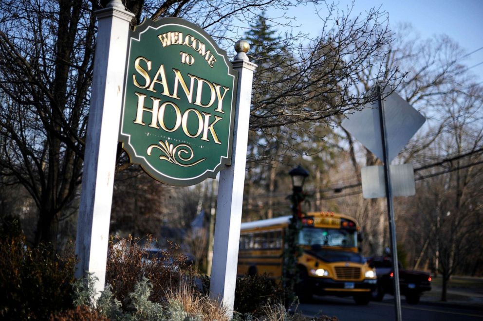 PHOTO: A bus drives past a sign reading Welcome to Sandy Hook in Newtown, Conn., Dec. 4, 2013.
