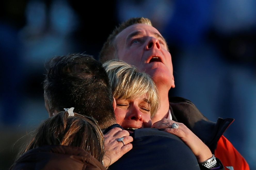 PHOTO: Lynn and Christopher McDonnell, the parents of seven-year-old Grace McDonnell, grieve near Sandy Hook Elementary after learning their daughter killed after a gunman opened fire inside the school in Newtown, Conn., Dec. 14, 2012.